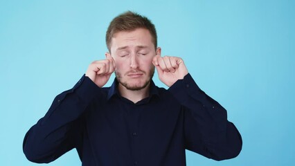 Crying man. Despair sorrow. Sadness melancholy. Boomerang motion. Unhappy frustrated guy wipes fake tears gesture isolated on blue background GIF loop animation.