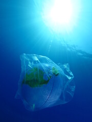 globe earth world in plastic bag underwater  pollution ocean