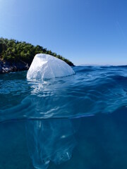 split shot of plastic bag underwater ocean pollution global waste like iceberg