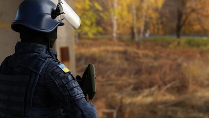 Ukraine army soldier looking in to the forest