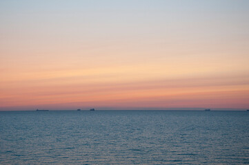 Naklejka na ściany i meble sunrise sky and sea with ship on horizon, summer