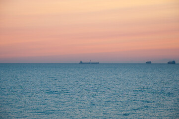 sunrise morning sky and sea with boat on horizon, summer