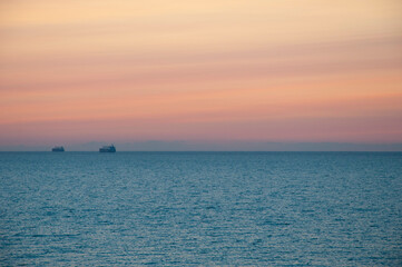 Obraz premium sunrise morning sky and sea with ship on horizon, summer. copy space