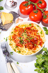 Mediterranean Italian pasta lunch. Classic pasta with marinara sauce, farfalle pasta with tomato sauce, cheese, fresh herbs 