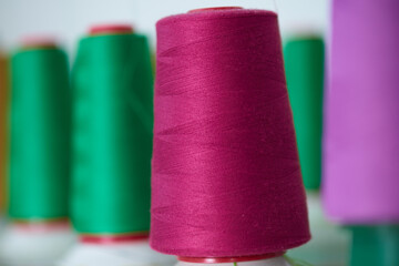 Colorful Thread rolls on a professional knitting machine