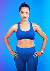 Fototapeta na wymiar If it doesnt challenge you, it doesnt change you. Studio portrait of an attractive young sportswoman posing against a blue background.