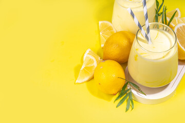 Creamy lemon fruit smoothie, yogurt ar milkshake, Sour sweet drink with fresh lemons on white...
