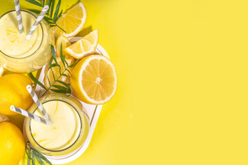 Creamy lemon fruit smoothie, yogurt ar milkshake, Sour sweet drink with fresh lemons on white...