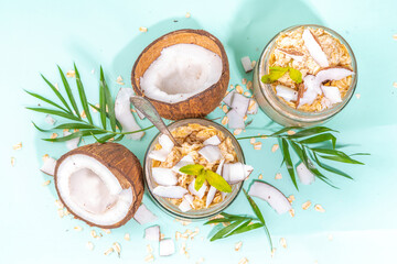 Breakfast overnight oatmeal oats with coconut milk and fresh coconut pieces. Diet healthy food,...