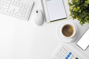 Office desk with laptop, blank notebook and coffee cup