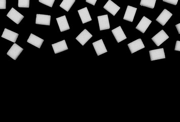 Obraz premium Natural white sugar cubes isolated on black background