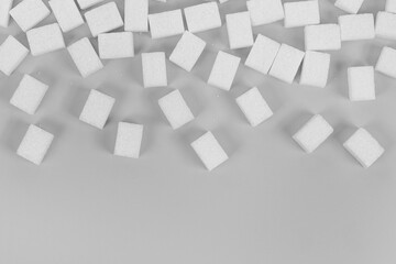 Fototapeta na wymiar Natural white sugar cubes isolated on gray background