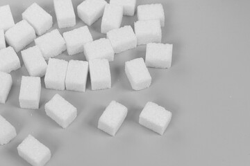 Natural white sugar cubes isolated on gray background