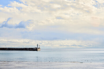 Obraz premium Sea embankment and lighthouse in the city of Yalta. Black Sea. Front view.