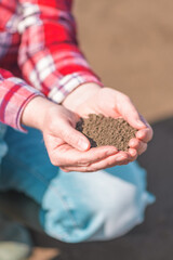 Female farmer holding soil in cupped hands