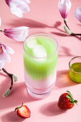 Strawberry matcha latte in a glass cup.