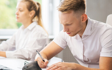 Team of professional support staff working in the office. Colleagues in the workplace solve customer problems. Call center and customer support concept.