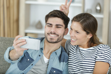 happy couple making selfie at home