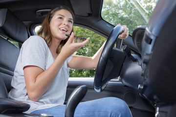 Fototapeta premium woman driving car and talking on phone