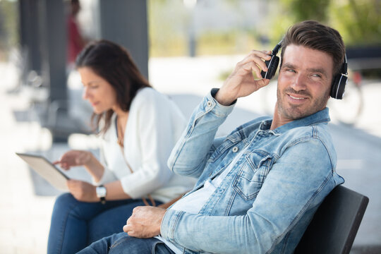 Two People Chatting At The Bus Stop