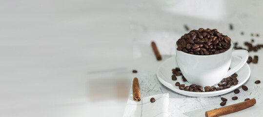 White cup and saucer with fragrant coffee beans