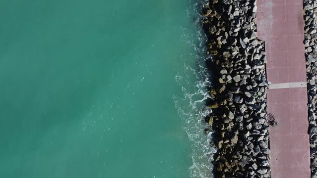 A view from above of the ocean waves crushing on the rocks in Tampico, Veracruz, Mexico