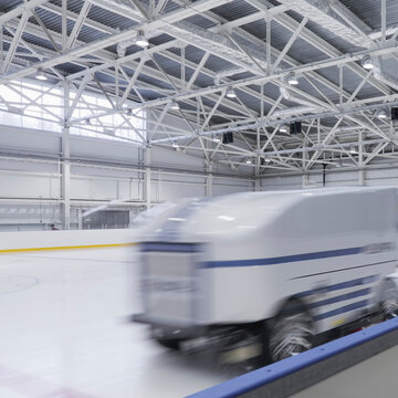 Zamboni ice resurfacing machinery, smoothing and repairing ice rink, motion blur. 