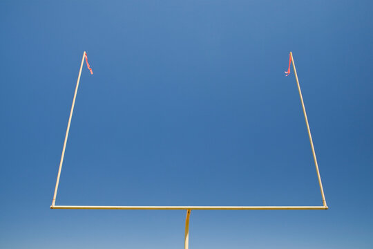 The upright silhouette of the scoring area of Football field goal posts, on a sports field 