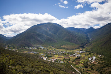 Traditional Tibetan village ina  beautiful valley on sunny day in Yunnan province