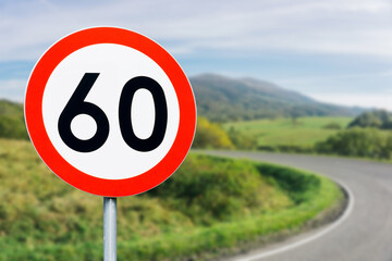 Speed limit sign with curvy road behind. Maximum sixty kilometers per hour. Safety on road background. White round sign red border line. Traffic ticket background. Speeding fine. Slow down on turn. - obrazy, fototapety, plakaty
