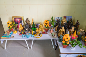 Many Buddha statues were laid together to allow the general public to worship ,Vintage statue old Buddha on shelf in Buddhism' s house ,Buddha shelf