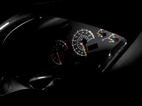 The dash,dashboard instruments and display,a speedometer,odometer of a sports car.