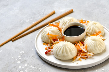  Bamboo steamers with tasty baozi dumplings, chopsticks and bowl of sauce. Chinese food delivery