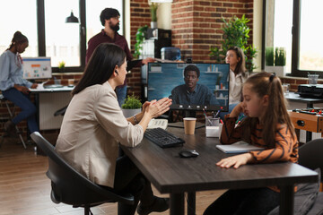 Business woman discussing with african american project manager about new partnerships. Financial company employee communicating to CEO fresh marketing strategies and ideas.