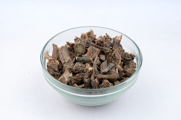  Giloy, also known as Tinospora, Guduchi, Cordifolia Closeup Over isolated White background over glass Bowl