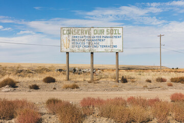 Conserve Our Soil message on a roadside billboard. 