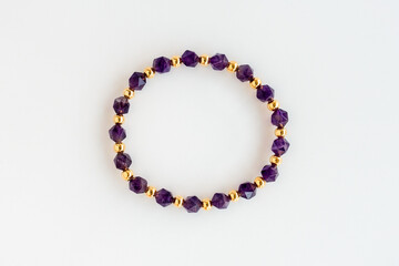 Amethyst Bracelet with Polygonal Beads and Round Gold Beads Isolated on White