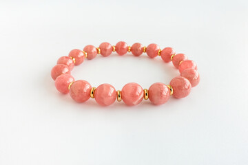 Argentina Rhodochrosite Bracelet with Gold Findings Isolated on White  