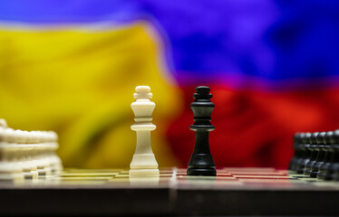 War between Russia and Ukraine, conceptual image of war using chess board, pieces and national...