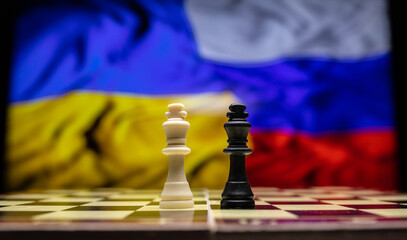 War between Russia and Ukraine, conceptual image of war using chess board, pieces and national...