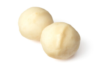 Unshelled macadamia nuts isolated on white background.