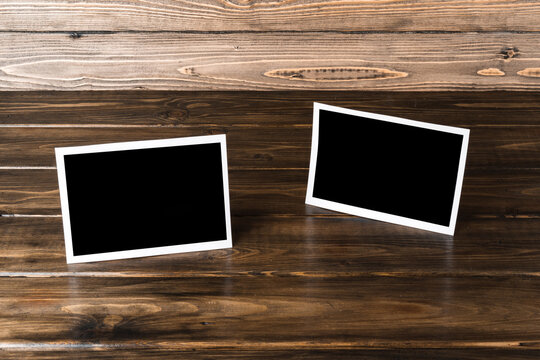 Blank photo frames for your photos on wooden background