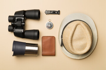 Travel accessories for mountain trip on color background, top view