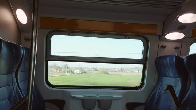 interior of a train with empty seats and window