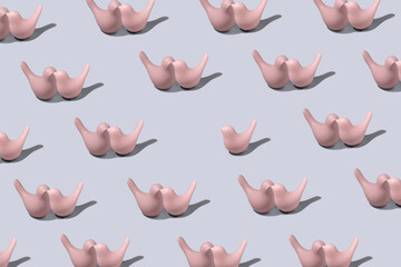 A metaphorical display of not fitting into society. Single person concpet. 
Pattern birds on blue pastel background