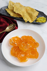 Popular Indian sweet Jalebi and Fafda served with Sambhara. Gujarati snack is mostly eaten during Indian Festivals such as, Gudi Padwa, Dussehra, Eid, Diwali, Mahashivratri, Holi. with Copy space.