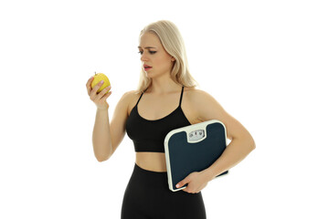 Sporty woman with apple and scales isolated on white background