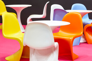 Contemporary multi colored plastic chairs and tables. Kindergarten interior. Nobody