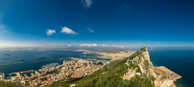 panoramic view of the Rock of Gibraltar and it's old military facilities, with Gibraltar itself and Spain in the background 
