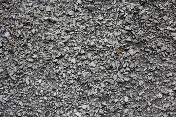 Rough gray dry rubble surface close-up, texture of industrial background.